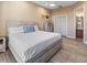 Calming main bedroom with wood-look tile, closet, and a view to the en suite bathroom at 3702 El Centro St, St Pete Beach, FL 33706