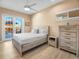 Calming main bedroom with wood-look tile, closet, and a view to the back patio at 3702 El Centro St, St Pete Beach, FL 33706