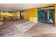 Covered patio with yellow walls, brick flooring, and outdoor seating at 3702 El Centro St, St Pete Beach, FL 33706