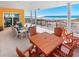 A well-furnished outdoor patio overlooking white sand dunes and the blue ocean at 3702 El Centro St, St Pete Beach, FL 33706