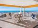 Outdoor patio with seating, including a dining set and beach loungers, offering ocean views at 3702 El Centro St, St Pete Beach, FL 33706