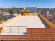 Rooftop featuring a yellow stucco wall, a terrace with metal railing, and terracotta roof tiles at 3702 El Centro St, St Pete Beach, FL 33706