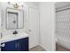 Modern bathroom with navy vanity, hexagon tile, and updated fixtures at 3717 Trophy Blvd, New Port Richey, FL 34655