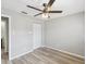 Bedroom with wood-look floors, ceiling fan, and double closet at 3717 Trophy Blvd, New Port Richey, FL 34655