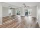 Bright living room with wood-look floors and mirrored wall at 3717 Trophy Blvd, New Port Richey, FL 34655