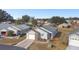 Aerial view of a single-Gathering home with a gray roof and brick accents at 37401 Wedgewood Dr, Zephyrhills, FL 33542