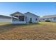 Home with screened porch and grassy backyard at 37401 Wedgewood Dr, Zephyrhills, FL 33542