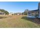 Home with screened porch and grassy backyard at 37401 Wedgewood Dr, Zephyrhills, FL 33542