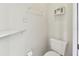 Small bathroom with toilet and wall shelving at 37401 Wedgewood Dr, Zephyrhills, FL 33542