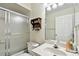 Clean bathroom with shower/tub combo, vanity, and linen shelf at 37401 Wedgewood Dr, Zephyrhills, FL 33542