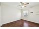 Bright bedroom with dark wood floors and ceiling fan at 37401 Wedgewood Dr, Zephyrhills, FL 33542