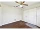 Bright bedroom with wood floors, ceiling fan and window with blinds at 37401 Wedgewood Dr, Zephyrhills, FL 33542