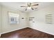 Bedroom with wood floors, ceiling fan, and wall shelves at 37401 Wedgewood Dr, Zephyrhills, FL 33542