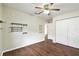 Bedroom with wood floors, closet, and ceiling fan at 37401 Wedgewood Dr, Zephyrhills, FL 33542