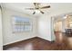 Bright dining room features dark wood floors, ceiling fan and view into adjacent room at 37401 Wedgewood Dr, Zephyrhills, FL 33542