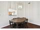 Bright dining room with oval table and chairs, kitchen view at 37401 Wedgewood Dr, Zephyrhills, FL 33542