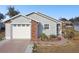 Ranch-style home with brick and gray siding, a garage, and landscaping at 37401 Wedgewood Dr, Zephyrhills, FL 33542