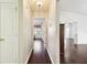 Light hallway with dark wood flooring, access to bedrooms at 37401 Wedgewood Dr, Zephyrhills, FL 33542