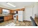 Kitchen with wood cabinets, white appliances, and tiled floor at 37401 Wedgewood Dr, Zephyrhills, FL 33542