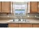 Double sink and wood cabinets in this kitchen at 37401 Wedgewood Dr, Zephyrhills, FL 33542