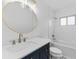 Modern bathroom with a navy vanity, gold fixtures, and white tile at 3915 Briarlake Dr, Valrico, FL 33596