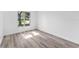 Well-lit bedroom, featuring wood-look floors and a window at 3915 Briarlake Dr, Valrico, FL 33596