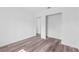 Bright bedroom with wood-look floors and access to hallway at 3915 Briarlake Dr, Valrico, FL 33596