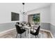 Modern dining area with a white table and black chairs, complemented by stylish decor at 3915 Briarlake Dr, Valrico, FL 33596