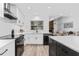 Modern kitchen with white cabinets, stainless steel appliances, and a herringbone backsplash at 3915 Briarlake Dr, Valrico, FL 33596