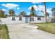 Newly renovated home with a light blue door, and a spacious yard at 4234 Des Moines Ne St, St Petersburg, FL 33703