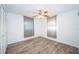 Bedroom with wood floors, a ceiling fan, and closet space at 435 Laughing Gull Ln, Palm Harbor, FL 34683