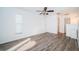 Bright bedroom featuring tile flooring, white walls, and neutral window shades at 435 Laughing Gull Ln, Palm Harbor, FL 34683