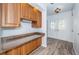 Foyer with wood-look flooring, a built-in counter area, and an inviting view of the front doors at 435 Laughing Gull Ln, Palm Harbor, FL 34683