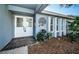 Inviting front entrance with double doors, a decorative water feature, and lush landscaping at 435 Laughing Gull Ln, Palm Harbor, FL 34683