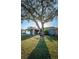 Charming single story home with stone accents and a large tree providing ample shade on a sunny day at 435 Laughing Gull Ln, Palm Harbor, FL 34683