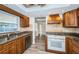 Stylish kitchen showcases granite counters, stainless appliances, and wood cabinets at 435 Laughing Gull Ln, Palm Harbor, FL 34683