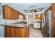 Well-lit kitchen featuring granite countertops and stainless steel appliances at 435 Laughing Gull Ln, Palm Harbor, FL 34683