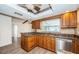 Well-lit kitchen featuring wood cabinets, granite countertops, and stainless steel appliances at 435 Laughing Gull Ln, Palm Harbor, FL 34683