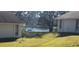 Scenic view of the lake from the backyard with green space and mature trees at 440 Lakeview Dr # 33, Palm Harbor, FL 34683