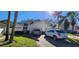 Well-maintained townhome with an attached garage, driveway, and a lush green lawn at 440 Lakeview Dr # 33, Palm Harbor, FL 34683