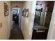 Hallway with wood laminate flooring and a view to the bedroom and bathroom at 440 Lakeview Dr # 33, Palm Harbor, FL 34683