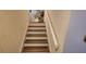 Well-lit staircase with wooden steps and white risers at 440 Lakeview Dr # 33, Palm Harbor, FL 34683