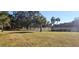 Well-maintained landscaping with a white fence lining the community street at 440 Lakeview Dr # 33, Palm Harbor, FL 34683