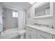 Bright bathroom, featuring a white vanity, shower/tub, and mosaic tile at 4455 Duhme Rd # 305, St Petersburg, FL 33708