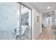 Light-filled hallway with glass doors leading to a sunroom and views of the ocean at 4455 Duhme Rd # 305, St Petersburg, FL 33708