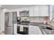 Modern kitchen with stainless steel appliances and white shaker cabinets at 4455 Duhme Rd # 305, St Petersburg, FL 33708