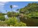 Peaceful waterfront view featuring calm water and abundant greenery at 4455 Duhme Rd # 305, St Petersburg, FL 33708