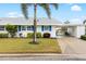 White single story home with blue shutters, landscaping, and driveway at 4519 Lexington Cir # 4519, Bradenton, FL 34210