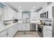 Modern kitchen with white cabinetry, stainless steel appliances, and granite countertops at 4519 Lexington Cir # 4519, Bradenton, FL 34210