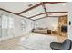 Living room with hardwood floors, stone fireplace and vaulted ceiling with exposed beams at 4535 33Rd N Ave, St Petersburg, FL 33713